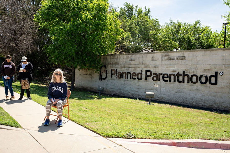 Woman prays before Planned Parenthood